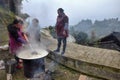 GUIZHOU PROVINCE, CHINA Ã¢â¬â CIRCA DECEMBER 2017: Three women cook a rice on the occasion of wedding feast hold outside